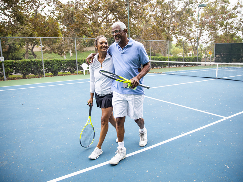 couple walking in tennis court